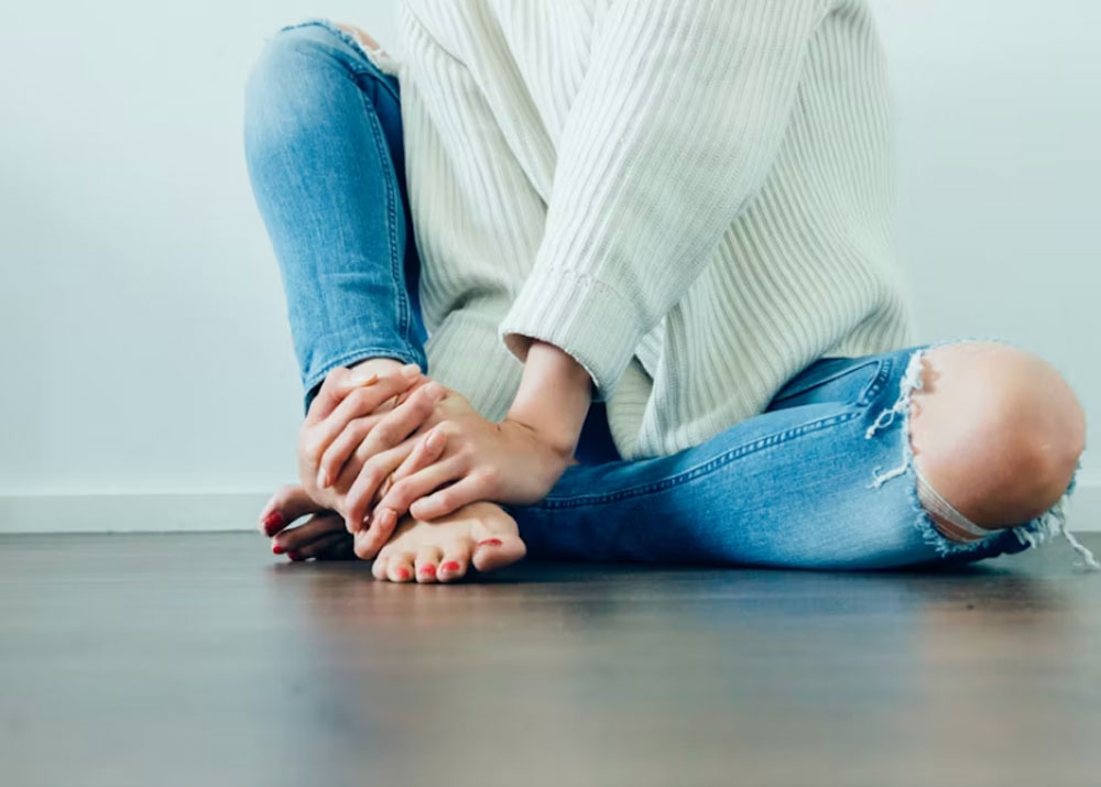 Girl in jeans sitting on the floor